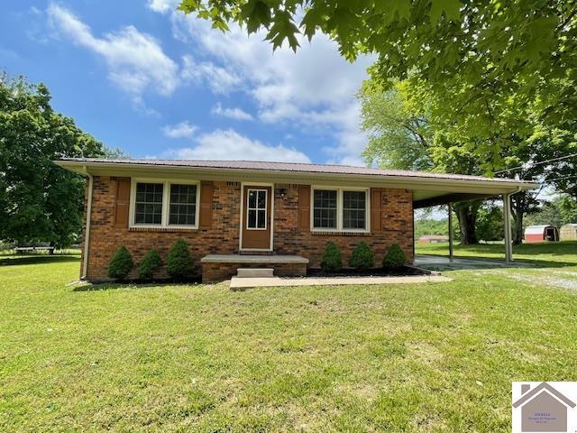 197 Briarfield Ln, Cadiz, KY 42211 - view of front of home with a front yard, a carport, and brick siding