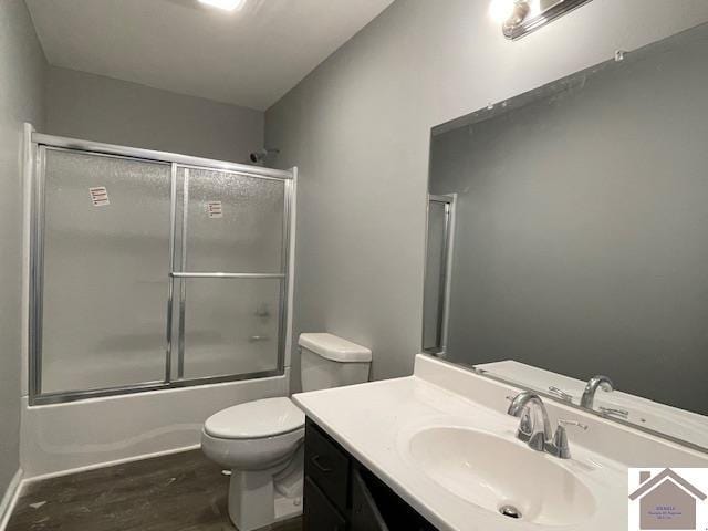 197 Briarfield Ln, Cadiz, KY 42211 - bathroom featuring wood finished floors, toilet, vanity, and shower / bath combination with glass door
