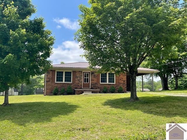 197 Briarfield Ln, Cadiz, KY 42211 - view of front of house with a front lawn, brick siding, and metal roof