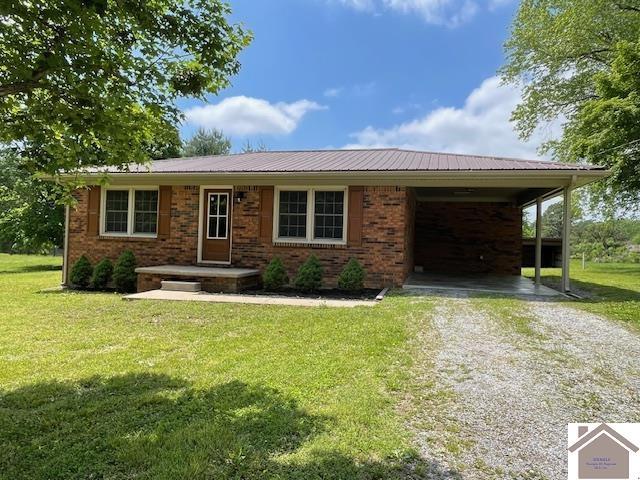 197 Briarfield Ln, Cadiz, KY 42211 - ranch-style house with driveway, a front yard, brick siding, and metal roof