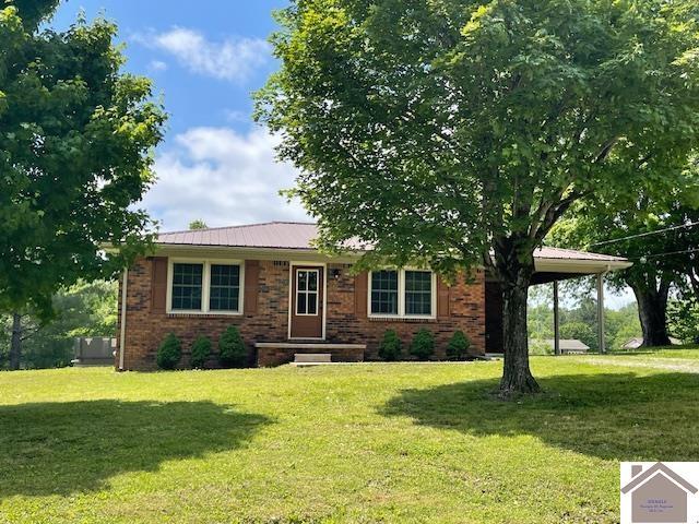197 Briarfield Ln, Cadiz, KY 42211 - view of front facade featuring a front yard, brick siding, and metal roof