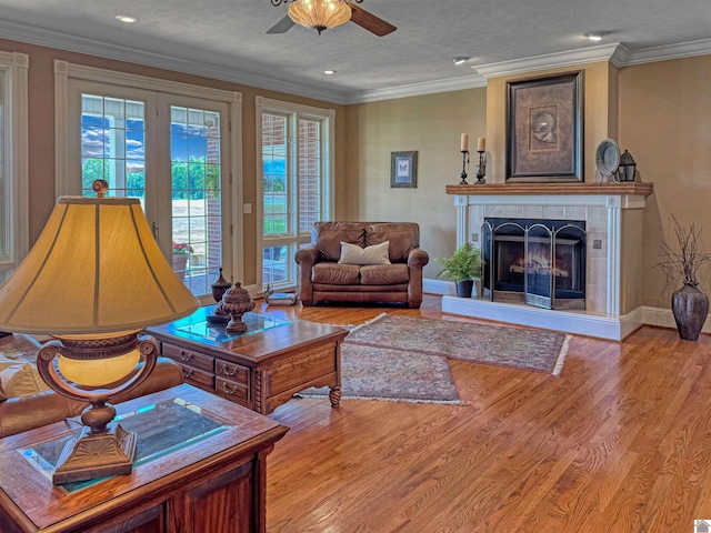 730 Rob Mason Rd, Murray, KY 42071 - living room with ceiling fan, wood finished floors, a tiled fireplace, recessed lighting, and crown molding
