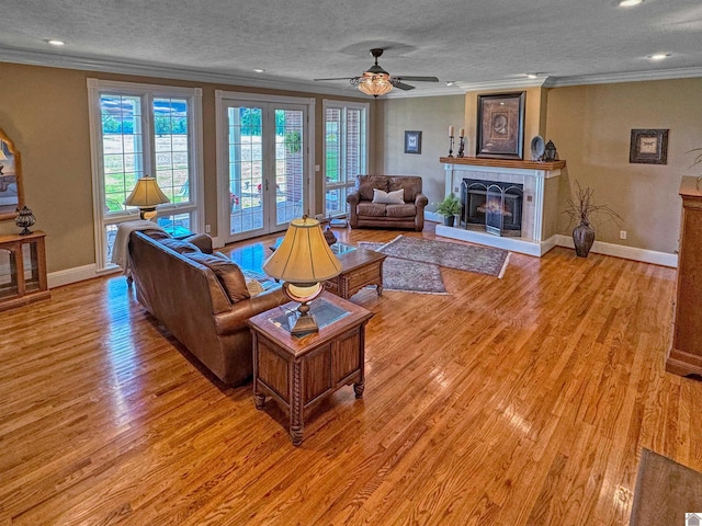 730 Rob Mason Rd, Murray, KY 42071 - living room featuring crown molding, light wood-style floors, baseboards, a textured ceiling, and a ceiling fan