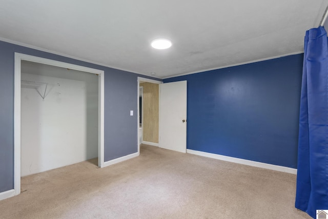 unfurnished bedroom featuring carpet flooring, crown molding, and baseboards