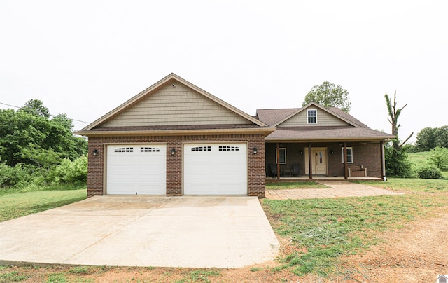1300 Rocky Rd, Fancy Farm, KY 42039 - view of front of house featuring an attached garage, a porch, brick siding, concrete driveway, and a front lawn