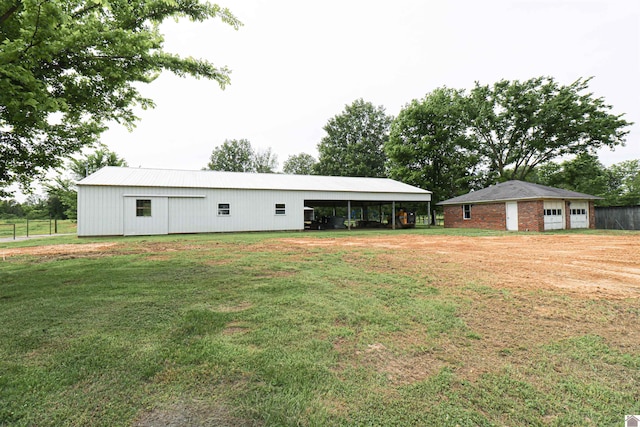 1300 Rocky Rd, Fancy Farm, KY 42039 - view of front of home with a pole building, a front yard, an outbuilding, and a carport