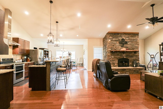 1300 Rocky Rd, Fancy Farm, KY 42039 - kitchen featuring appliances with stainless steel finishes, open floor plan, lofted ceiling, a fireplace, and extractor fan