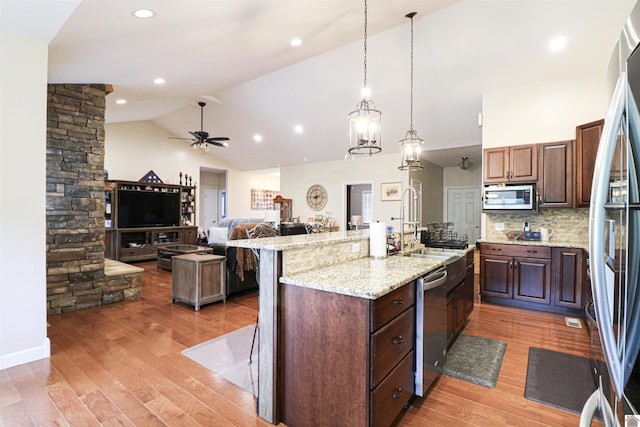 1300 Rocky Rd, Fancy Farm, KY 42039 - kitchen with stainless steel appliances, open floor plan, a sink, a kitchen island with sink, and decorative backsplash