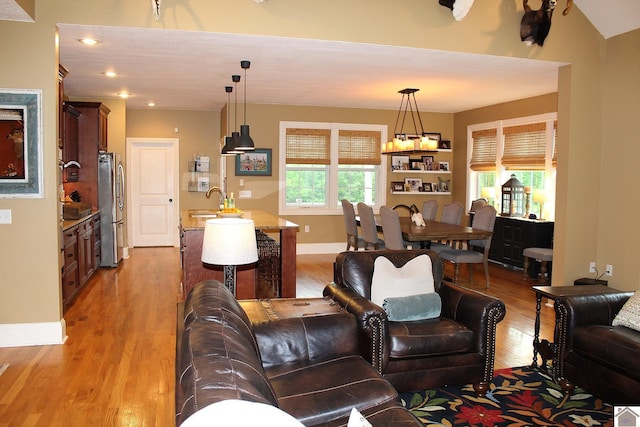 494 Beat Farmer Rd, New Concord, KY 42076 - living room featuring light wood finished floors, a chandelier, baseboards, and recessed lighting