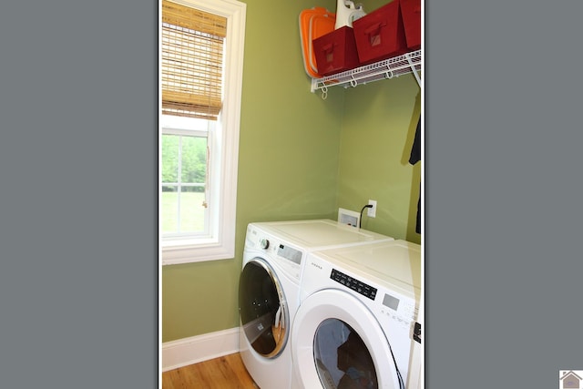 494 Beat Farmer Rd, New Concord, KY 42076 - washroom featuring washing machine and clothes dryer, baseboards, and light wood finished floors