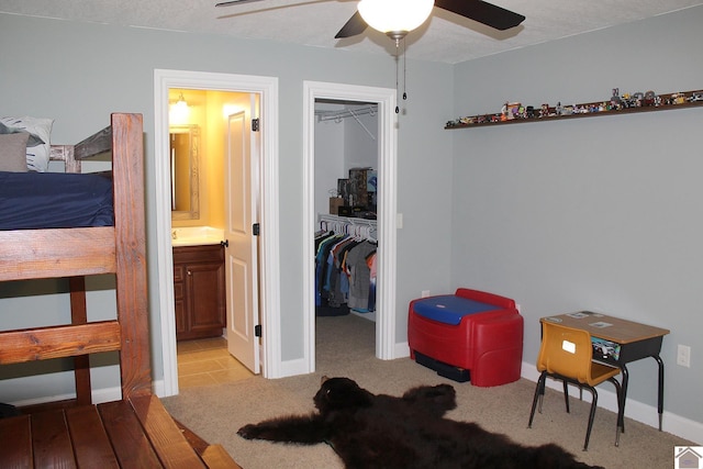 494 Beat Farmer Rd, New Concord, KY 42076 - bedroom featuring a closet, ensuite bath, a walk in closet, baseboards, and ceiling fan