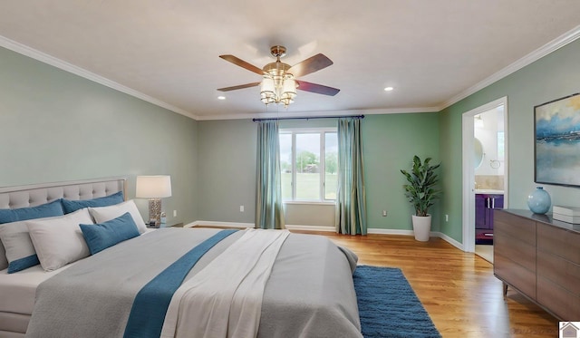 bedroom with ornamental molding, recessed lighting, baseboards, light wood-style flooring, and ensuite bathroom