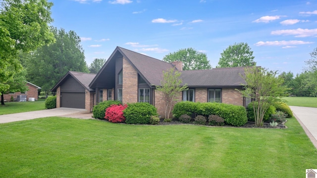 view of front facade with brick siding, driveway, a front lawn, and roof with shingles