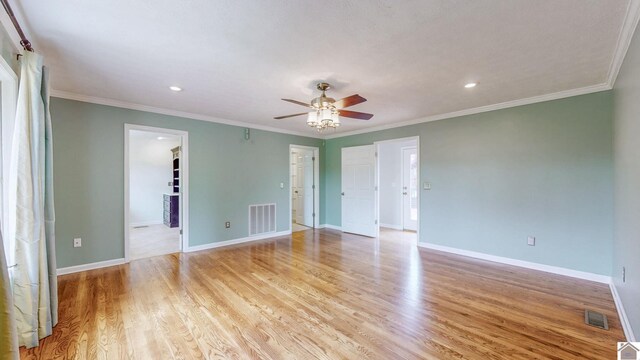 unfurnished bedroom with light wood-style floors, recessed lighting, baseboards, a spacious closet, and ornamental molding