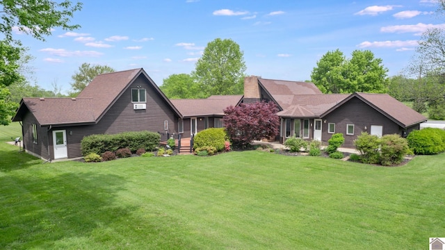 view of front of property with a front yard, a chimney, and a shingled roof
