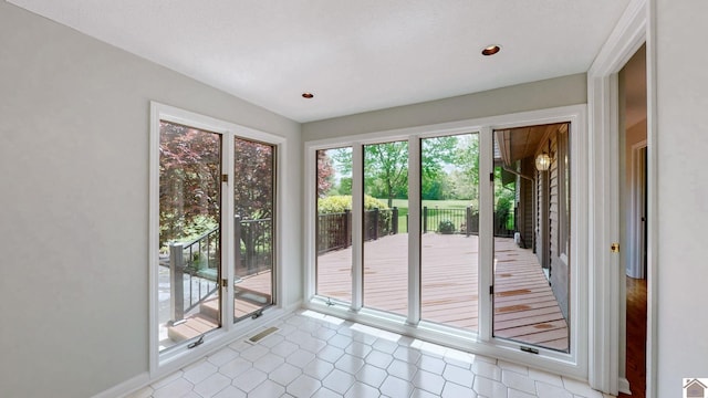 entryway featuring light tile patterned floors and recessed lighting