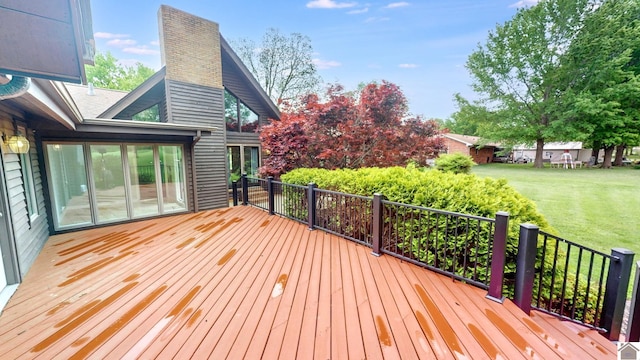 wooden terrace featuring a yard