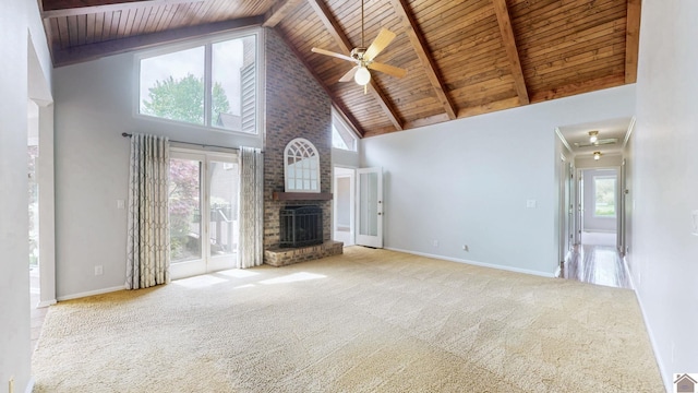 unfurnished living room featuring wooden ceiling, high vaulted ceiling, a ceiling fan, carpet flooring, and healthy amount of natural light