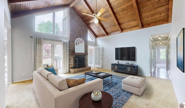 living room with wood ceiling, high vaulted ceiling, ceiling fan, carpet, and healthy amount of natural light
