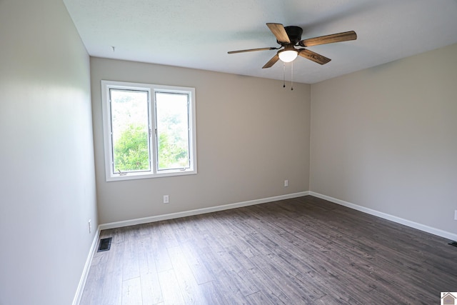 1809 Old Calvert City Rd, Calvert City, KY 42029 - spare room featuring wood finished floors, a ceiling fan, and baseboards