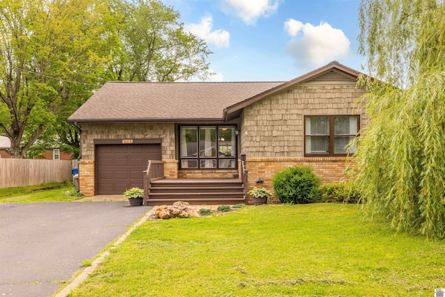 521 Whitnell Ave, Murray, KY 42071 - view of front facade featuring an attached garage, brick siding, driveway, and roof with shingles