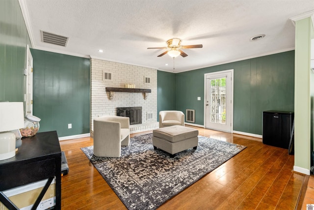 521 Whitnell Ave, Murray, KY 42071 - living room with ceiling fan, crown molding, hardwood / wood-style floors, a fireplace, and baseboards