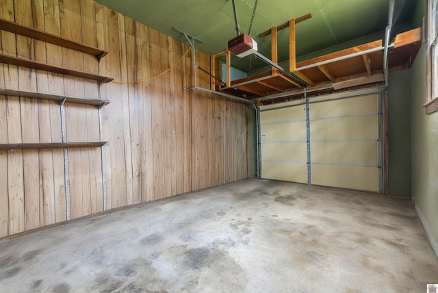 521 Whitnell Ave, Murray, KY 42071 - garage with wood walls and a garage door opener