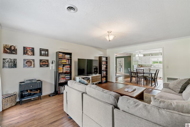 521 Whitnell Ave, Murray, KY 42071 - living room with light wood finished floors, a textured ceiling, crown molding, and baseboards