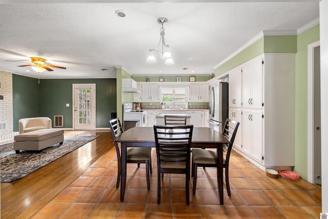 521 Whitnell Ave, Murray, KY 42071 - dining room with a textured ceiling, ornamental molding, plenty of natural light, ceiling fan, and a chandelier