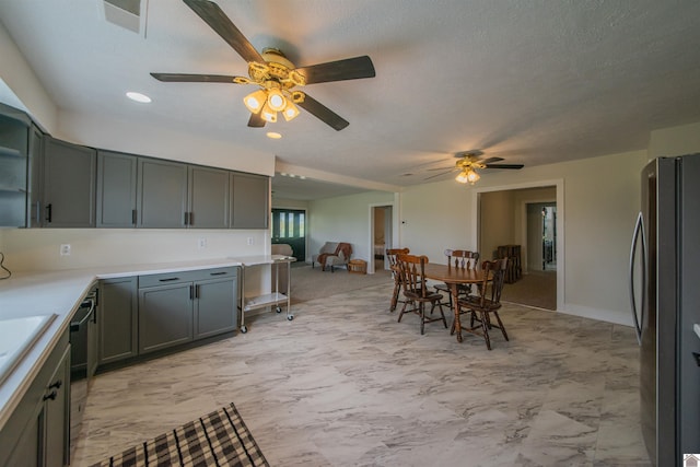 kitchen featuring freestanding refrigerator, ceiling fan, light countertops, open floor plan, and recessed lighting