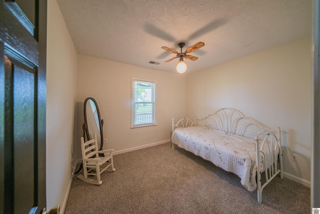 carpeted bedroom with baseboards, a textured ceiling, and a ceiling fan