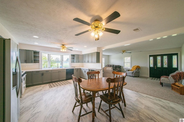 dining room featuring a textured ceiling, healthy amount of natural light, a ceiling fan, recessed lighting, and baseboards
