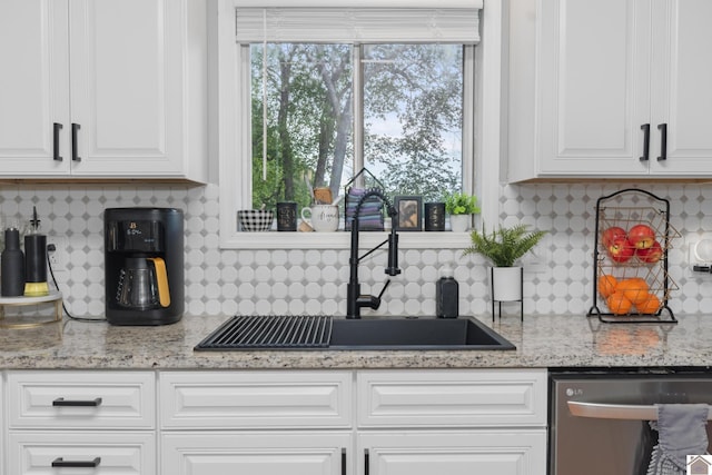 890 Ridge Rd, Gilbertsville, KY 42044 - kitchen featuring stainless steel dishwasher, a sink, white cabinetry, and backsplash