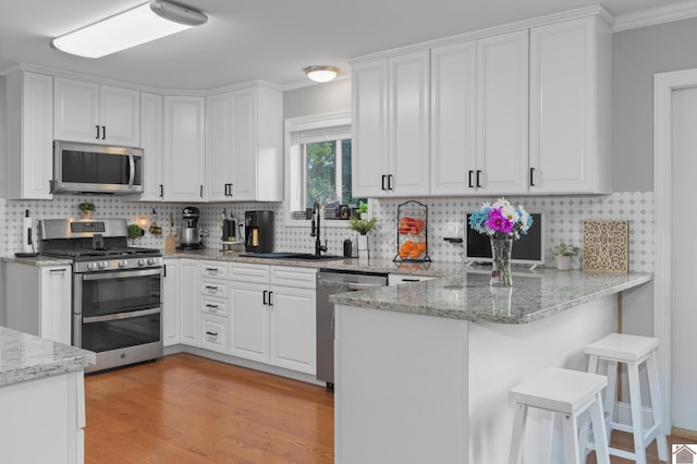 890 Ridge Rd, Gilbertsville, KY 42044 - kitchen with appliances with stainless steel finishes, a sink, and white cabinetry