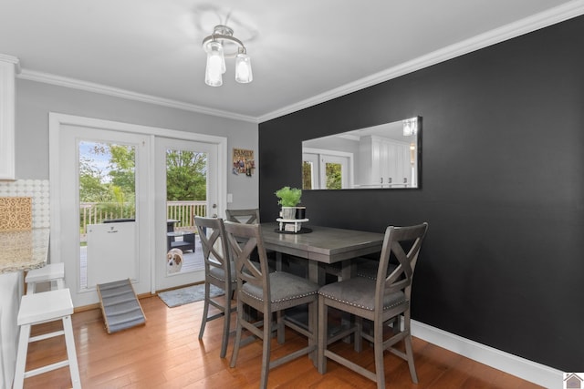 890 Ridge Rd, Gilbertsville, KY 42044 - dining space with light wood-style flooring, ornamental molding, and baseboards