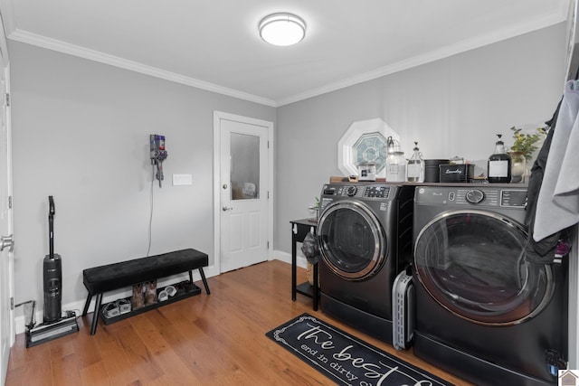 890 Ridge Rd, Gilbertsville, KY 42044 - laundry room featuring washer and clothes dryer, crown molding, wood finished floors, and baseboards