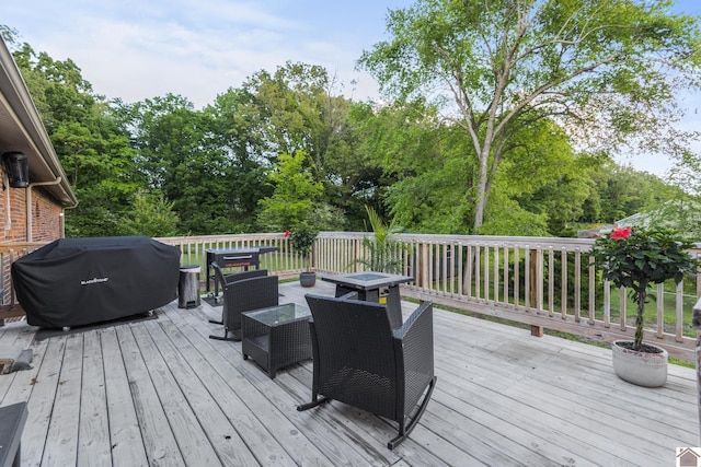 890 Ridge Rd, Gilbertsville, KY 42044 - deck featuring area for grilling, view of wooded area, and outdoor dining area