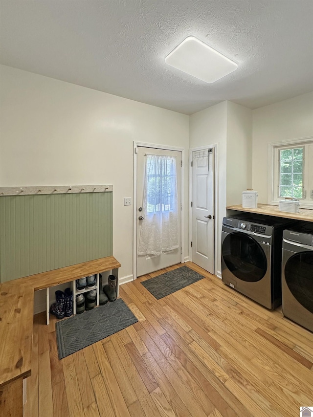 478 Lovers Ln, Benton, KY 42025 - clothes washing area with washer and clothes dryer, light wood-style floors, and a textured ceiling