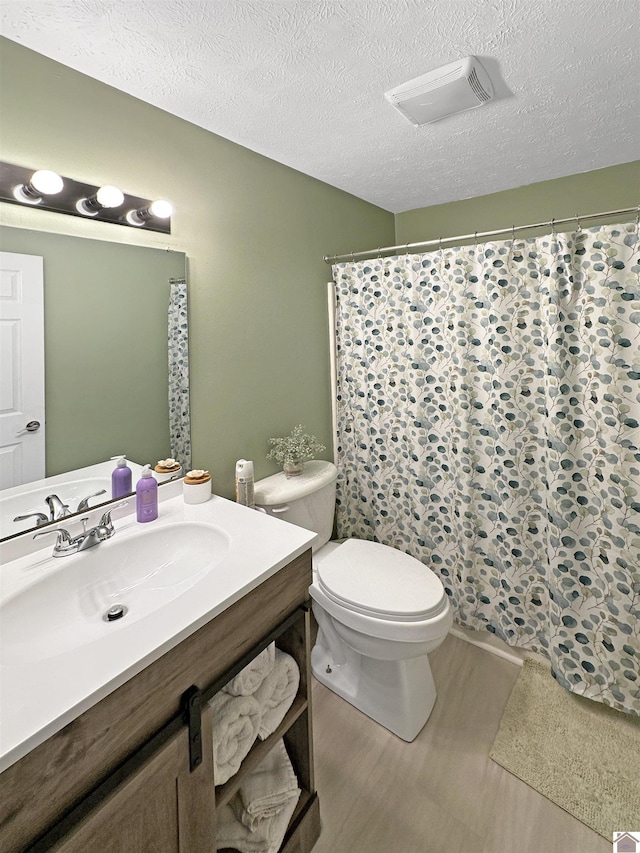 478 Lovers Ln, Benton, KY 42025 - bathroom featuring toilet, vanity, a textured ceiling, a shower with shower curtain, and wood finished floors