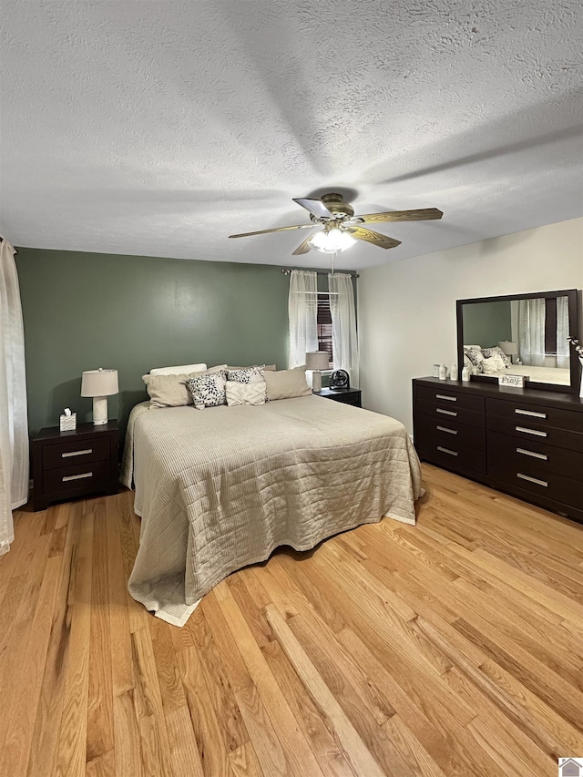 478 Lovers Ln, Benton, KY 42025 - bedroom with light wood-type flooring, a textured ceiling, and a ceiling fan