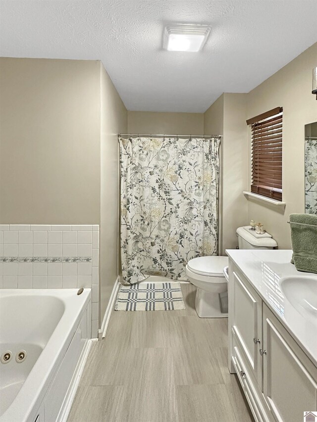 478 Lovers Ln, Benton, KY 42025 - bathroom featuring a whirlpool tub, vanity, a textured ceiling, toilet, and baseboards