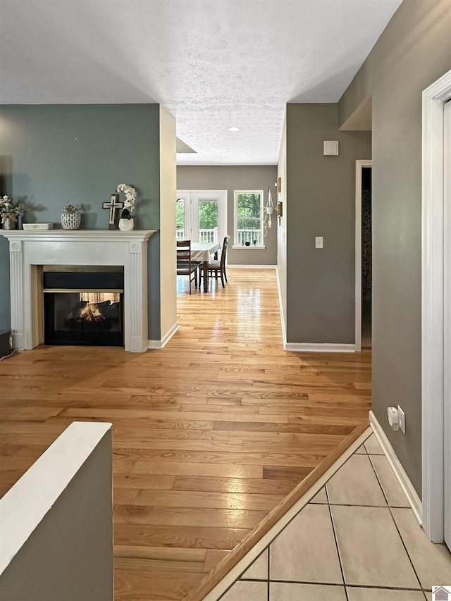 478 Lovers Ln, Benton, KY 42025 - corridor with baseboards, a textured ceiling, and wood finished floors