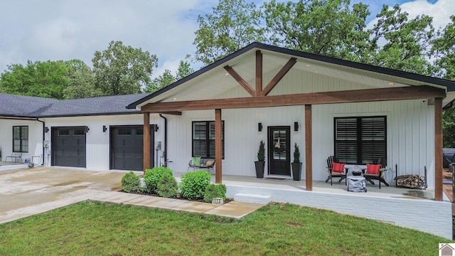 113 Captain Ln, Gilbertsville, KY 42044 - view of front of property with covered porch, a garage, driveway, and a front lawn