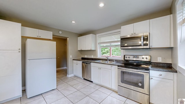 509 S 6th St, Murray, KY 42071 - kitchen with appliances with stainless steel finishes, a sink, dark countertops, white cabinetry, and recessed lighting