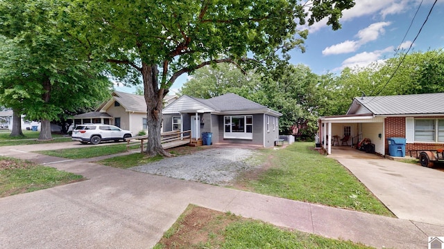 509 S 6th St, Murray, KY 42071 - bungalow featuring concrete driveway, brick siding, a front lawn, and a carport