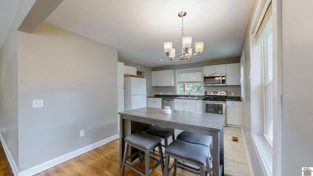 509 S 6th St, Murray, KY 42071 - kitchen featuring appliances with stainless steel finishes, a sink, dark countertops, and white cabinetry
