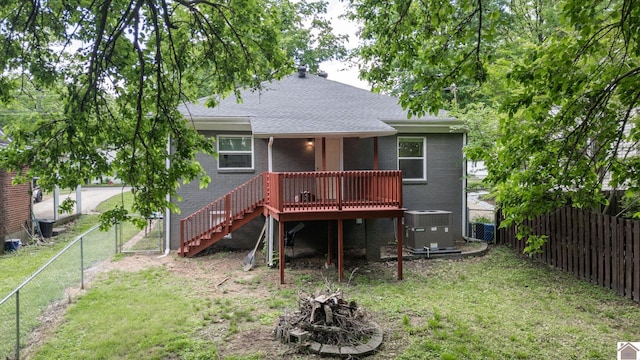 509 S 6th St, Murray, KY 42071 - back of house with brick siding, a fire pit, central AC, a wooden deck, and a shingled roof