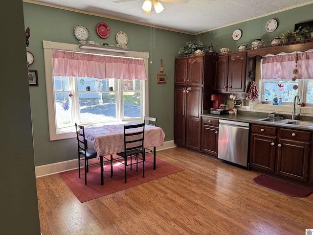 kitchen featuring dishwasher, a sink, light wood-type flooring, a textured ceiling, and ceiling fan