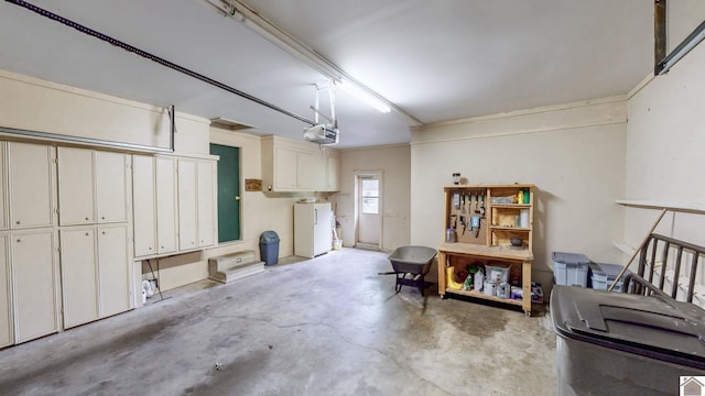 111 Honeysuckle Ln, Murray, KY 42071 - garage with a garage door opener and freestanding refrigerator