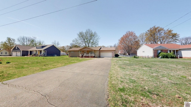 111 Honeysuckle Ln, Murray, KY 42071 - single story home featuring a front lawn, an attached garage, asphalt driveway, and a residential view